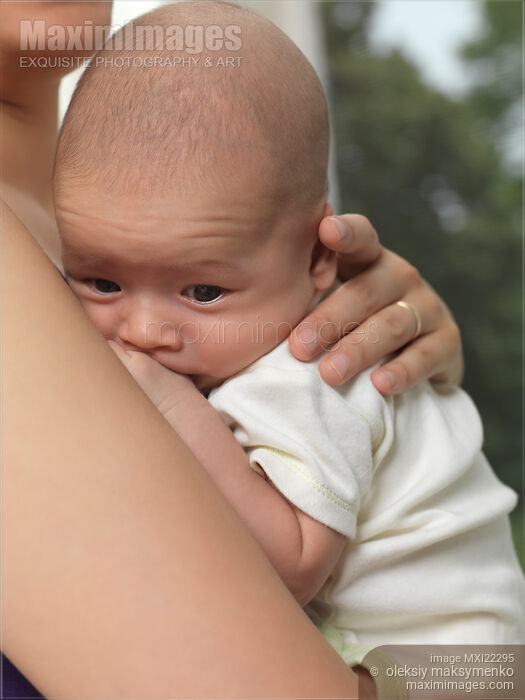 Stock photo of Baby Boy in Mother's Hands Buy commercial use license at MaximImages