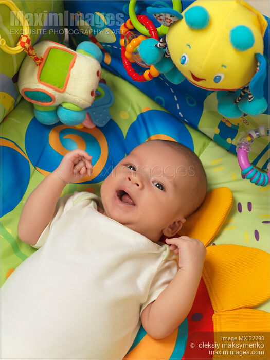 Stock photo of Baby Boy Lying on a Play Mat Buy commercial use license at MaximImages
