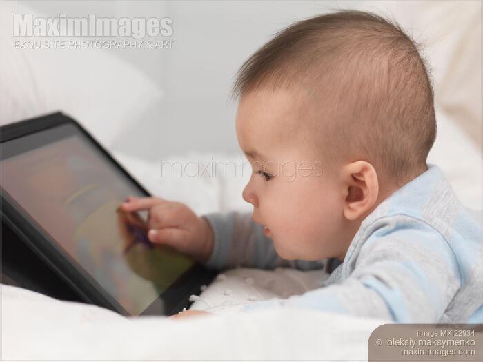 Stock photo of Baby Boy Playing with a Tablet Computer Buy commercial use license at MaximImages