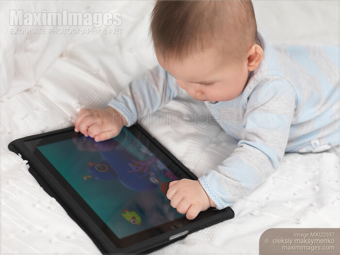 Stock photo of Baby Boy Playing with iPad Buy commercial use license at MaximImages