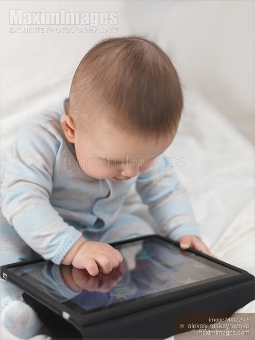 Stock photo of Baby Boy Playing with iPad Buy commercial use license at MaximImages