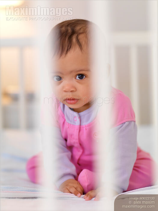 Stock photo of Baby Girl in a Crib Buy commercial use license at MaximImages