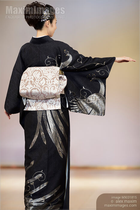 Back of a Japanese woman wearing elegant black kimono with obi at fashion show Stock photo of Back of a Japanese woman wearing elegant black kimono with obi at fashion show Buy commercial use license at MaximImages