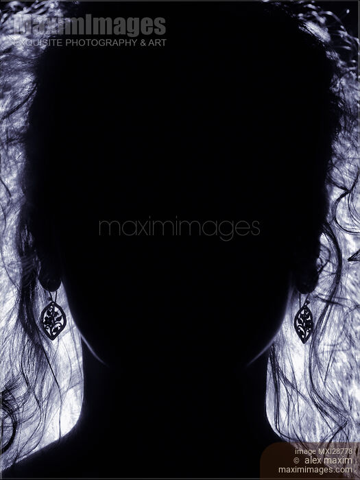 Stock photo of Backlit woman face with long hair dark silhouette Buy commercial use license at MaximImages