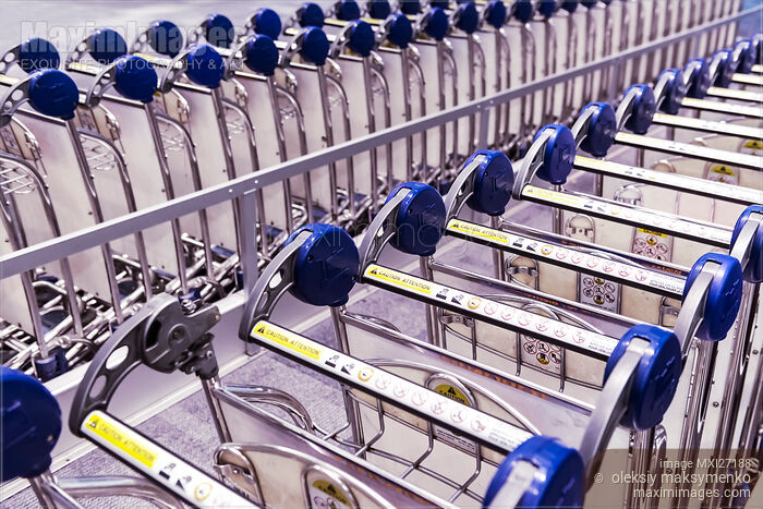 Stock photo of Baggage carts at an airport Buy commercial use license at MaximImages