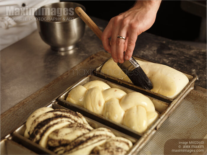 Stock photo of Baker Glazing Bread Buy commercial use license at MaximImages