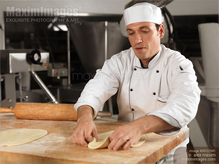 Baker Rolling Out Dough Stock photo of Baker Rolling Out Dough Buy commercial use license at MaximImages