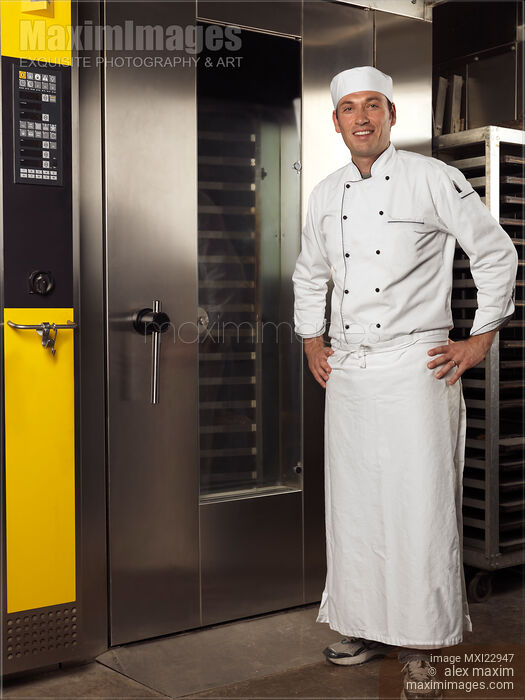 Stock photo of Baker Standing at a Bakery's Oven Buy commercial use license at MaximImages