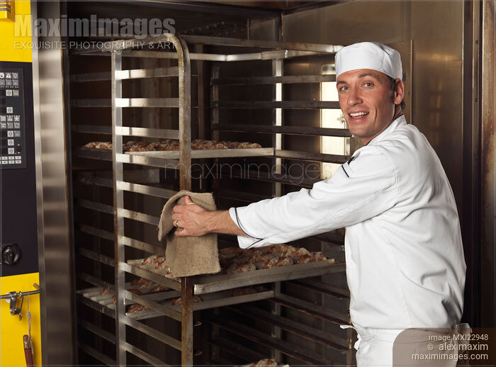 Baker Taking a Rack Trolley out of a Bakery's Oven Stock photo of Baker Taking a Rack Trolley out of a Bakery's Oven Buy commercial use license at MaximImages