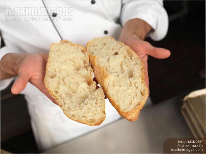 Stock photo of Baker with a Freshly Baked Bread in His Hands Buy commercial use license at MaximImages
