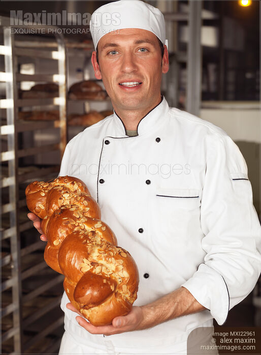 Stock photo of Baker with a Freshly Baked Challah Bread in His Hands Buy commercial use license at MaximImages