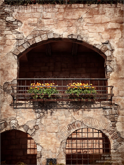 Stock photo of Balcony with flowers of old rustic house Buy commercial use license at MaximImages