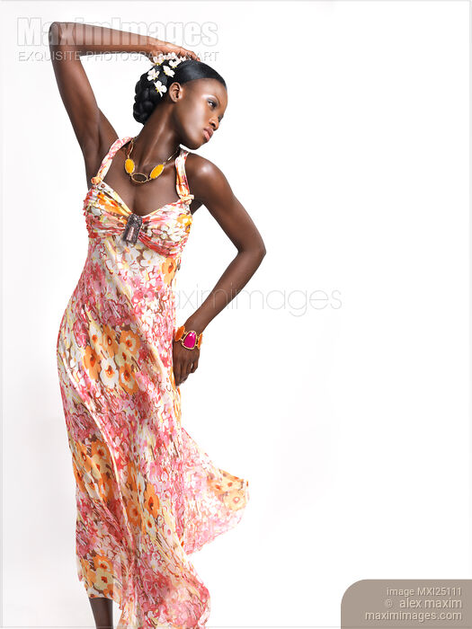 Stock photo of Beautiful african woman in pink summer dress Buy commercial use license at MaximImages
