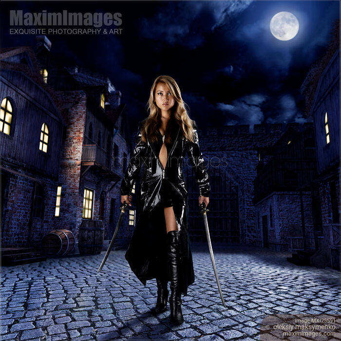 Stock photo of Beautiful asian lady assassin walking down night street with two swords Buy commercial use license at MaximImages