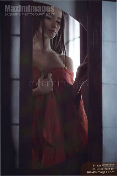 Beautiful Asian woman in undone red kimono standing by an open shoji window of a Japanese historic house Dramatic sensual portrait Stock photo of Beautiful Asian woman in undone red kimono standing by an open shoji window of a Japanese historic house Dramatic sensual portrait Buy commercial use license at MaximImages