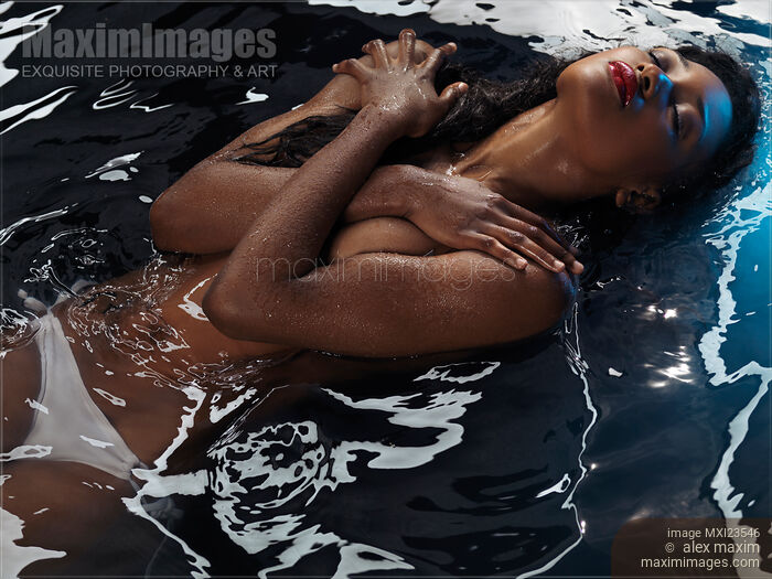 Beautiful black african-american woman lying in water half-naked Sensual portrait Stock photo of Beautiful black african-american woman lying in water half-naked Sensual portrait Buy commercial use license at MaximImages