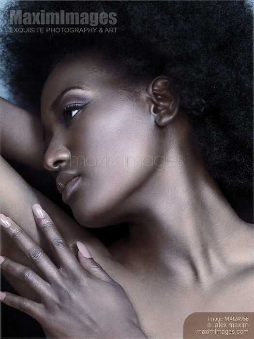 Stock photo of Beautiful black woman face with shiny silver skin Buy commercial use license at MaximImages