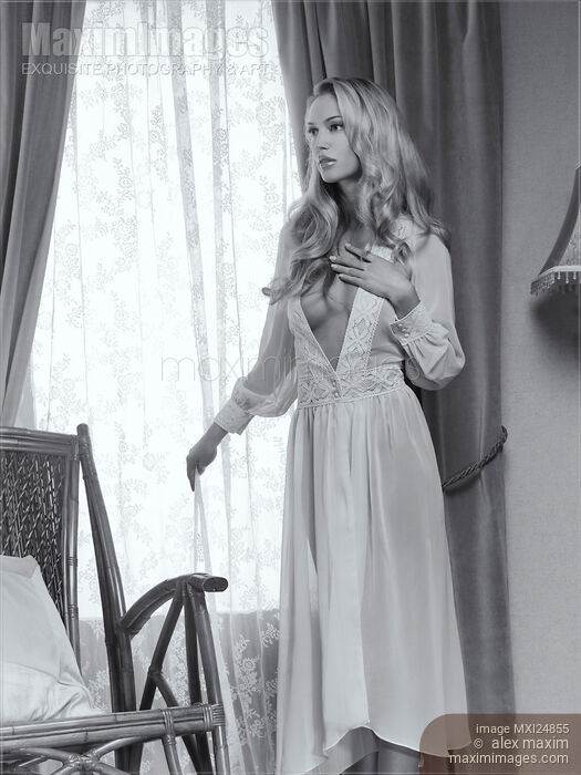 Beautiful blond woman in night gown by the window Black and white Stock photo of Beautiful blond woman in night gown by the window Black and white Buy commercial use license at MaximImages