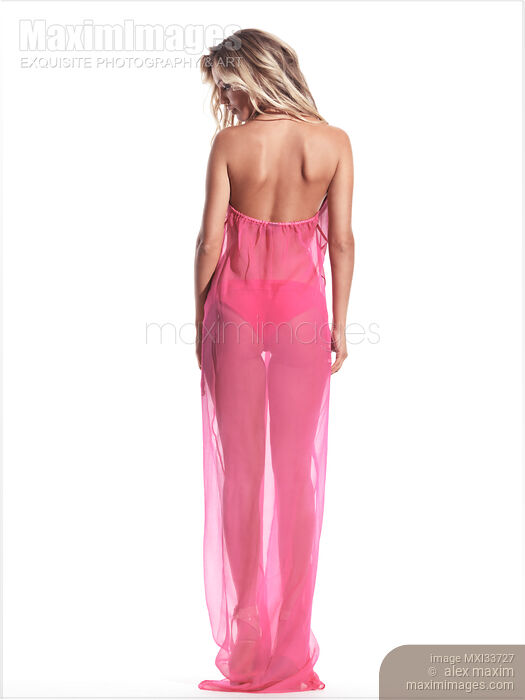 Stock photo of Beautiful blond young woman wearing pink beachwear beach cover revealing her back Buy commercial use license at MaximImages