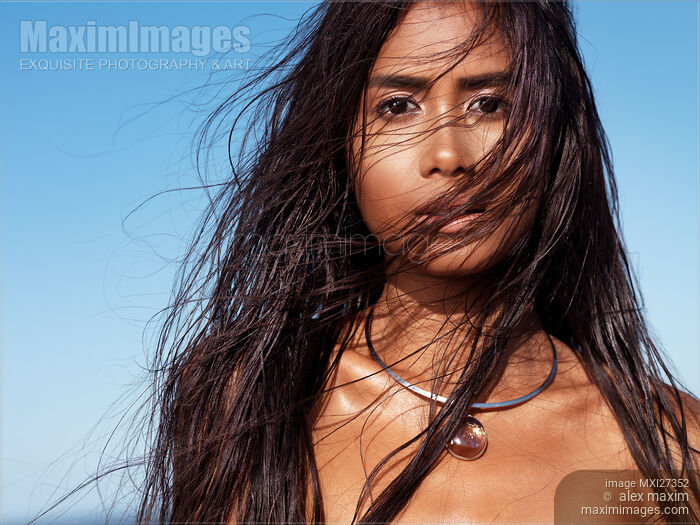 Stock photo of Beautiful exotic asian woman face with long wet dark hair Buy commercial use license at MaximImages