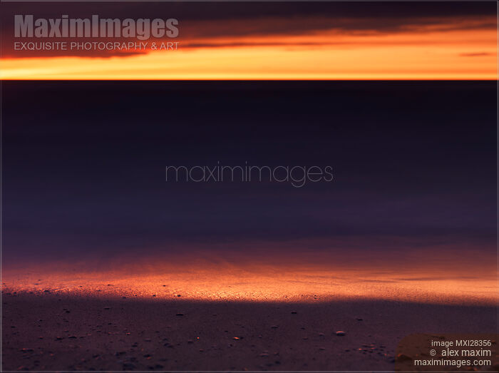 Beautiful golden sunset reflecing in the shore line of lake Huron Stock photo of Beautiful golden sunset reflecing in the shore line of lake Huron Buy commercial use license at MaximImages