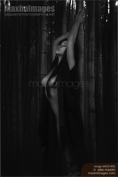 Beautiful half nude asian woman leaning against a bamboo in dark forest Black and white Stock photo of Beautiful half nude asian woman leaning against a bamboo in dark forest Black and white Buy commercial use license at MaximImages
