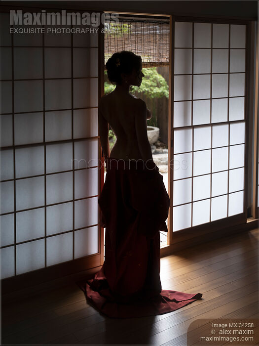 Stock photo of Beautiful half-nude woman with bared back standing by open shoji door of Japanese house with Zen garden Buy commercial use license at MaximImages