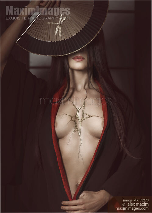 Stock photo of Beautiful Japanese woman in black kimono open on her chest showing cracks of broken heart filled with gold. Wabi-sabi Kintsugi concept. Buy commercial use license at MaximImages