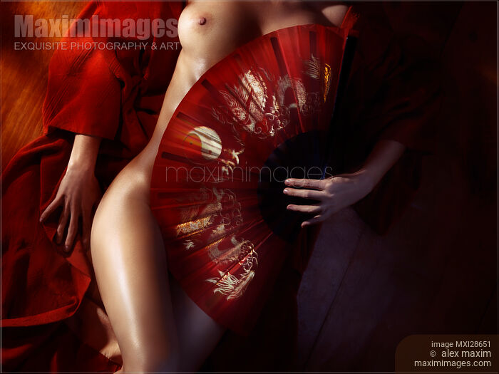 Beautiful naked woman body covered with red Asian fan Stock photo of Beautiful naked woman body covered with red Asian fan Buy commercial use license at MaximImages