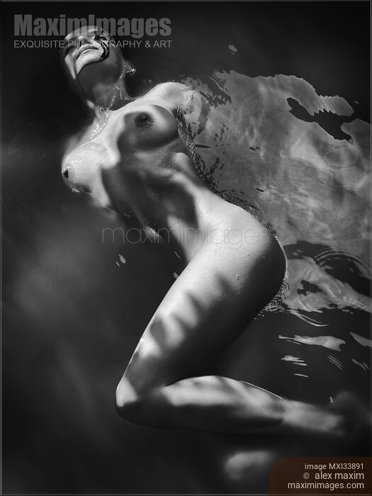 Beautiful nude woman lying in dark water with water droplets on her wet naked body Black and white Stock photo of Beautiful nude woman lying in dark water with water droplets on her wet naked body Black and white Buy commercial use license at MaximImages