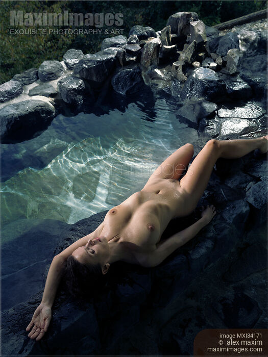 Beautiful nude woman with wet naked body lying on rocks of Japanese Onsen hot spring bath Stock Image MXI34171 © Alex Maxim / MaximImages