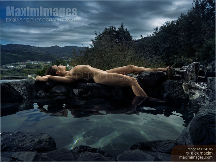 Beautiful nude woman with wet sexy naked body lying on rocks on the edge of onsen hot spring pool Stock photo of Beautiful nude woman with wet sexy naked body lying on rocks on the edge of onsen hot spring pool Buy commercial use license at MaximImages