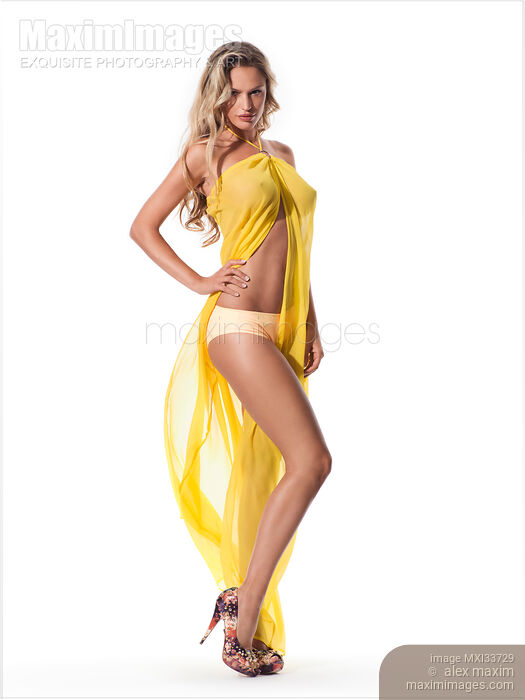 Stock photo of Beautiful sexy blond woman wearing bikini and yellow see-through beach wear cover Buy commercial use license at MaximImages