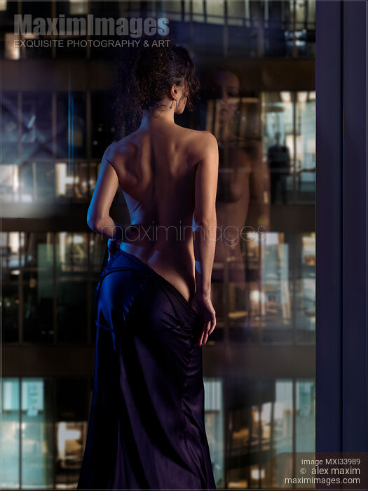 Beautiful sexy woman in undressing in front of a window with a man watching her seductive dance Stock photo of Beautiful sexy woman in undressing in front of a window with a man watching her seductive dance Buy commercial use license at MaximImages