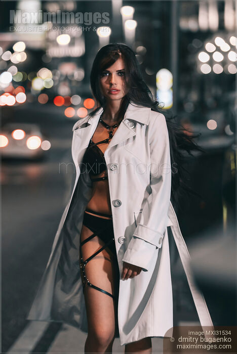 Stock photo of Beautiful sexy woman provocatively dressed walking on a city street Buy commercial use license at MaximImages
