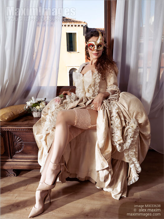Beautiful Venetian lady courtesan in a carnival mask flirting by raising her vintage dress revealing sexy legs in stockings Stock photo of Beautiful Venetian lady courtesan in a carnival mask flirting by raising her vintage dress revealing sexy legs in stockings Buy commercial use license at MaximImages
