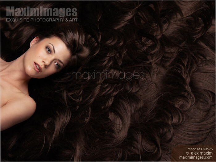 Stock photo of Beautiful Woman in a Sea of Hair Buy commercial use license at MaximImages