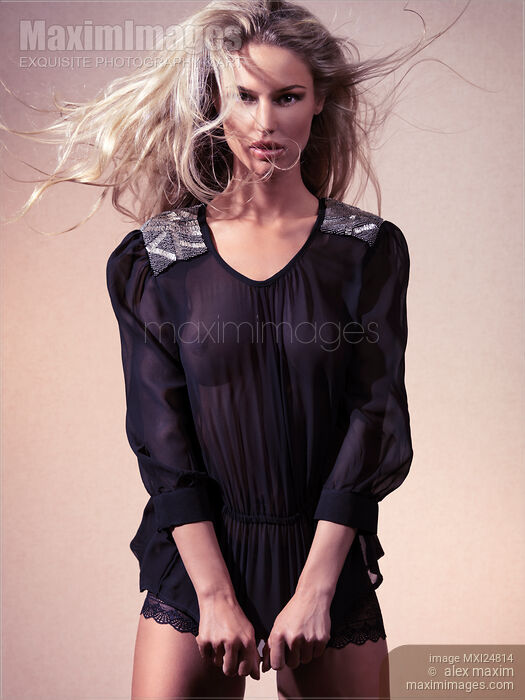Beautiful woman in black see-through top Stock photo of Beautiful woman in black see-through top Buy commercial use license at MaximImages