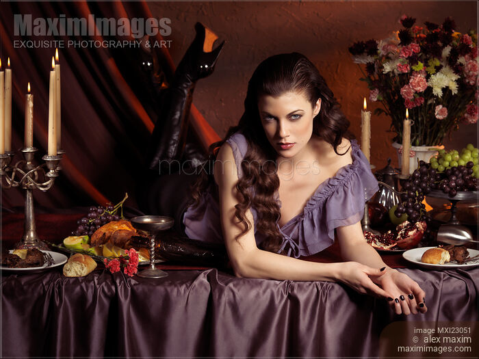 Stock photo of Beautiful Woman Lying on a Festive Table Buy commercial use license at MaximImages
