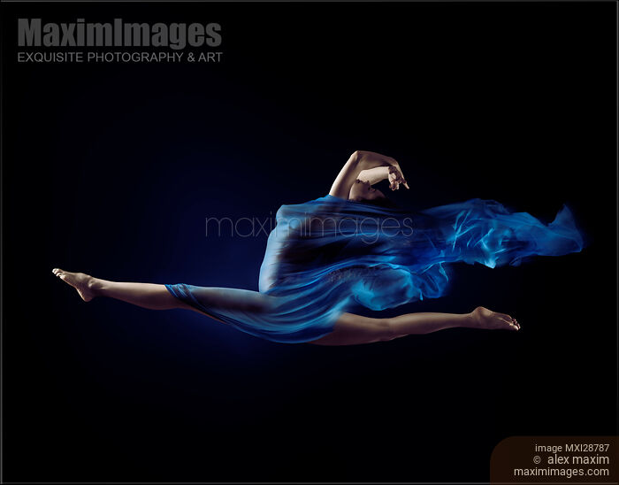 Beautiful woman making splits in the air with flowing blue cloth wrapped around her body Stock photo of Beautiful woman making splits in the air with flowing blue cloth wrapped around her body Buy commercial use license at MaximImages