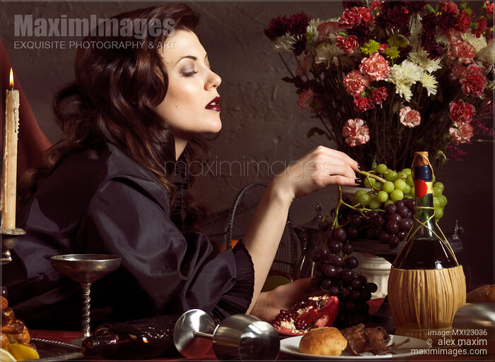 Stock photo of Beautiful Woman on a Festive Table Buy commercial use license at MaximImages