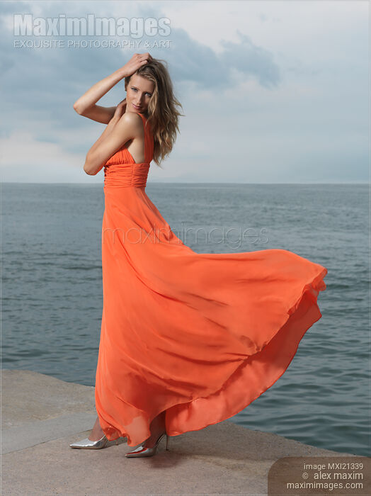 Stock photo of Beautiful Woman on a Sea Shore Buy commercial use license at MaximImages