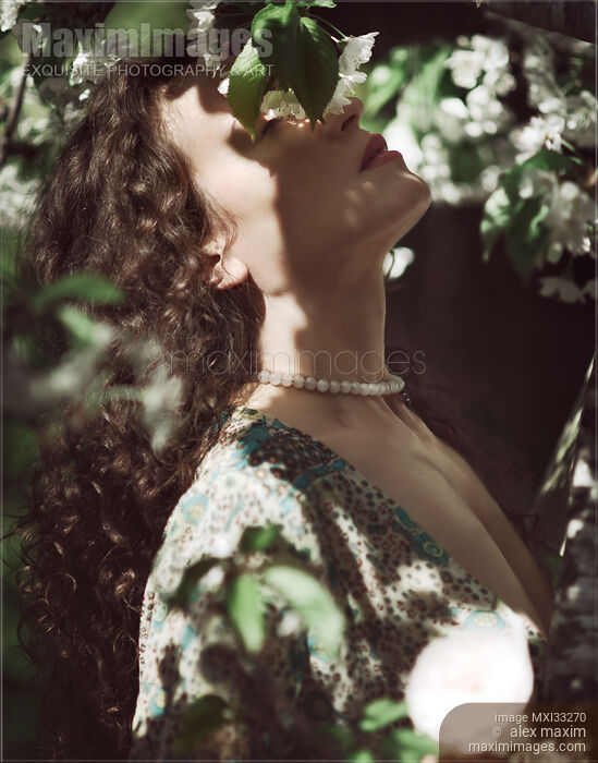 Beautiful woman profile of her face with closed eyes in cherry tree blossom white flowers Stock photo of Beautiful woman profile of her face with closed eyes in cherry tree blossom white flowers Buy commercial use license at MaximImages