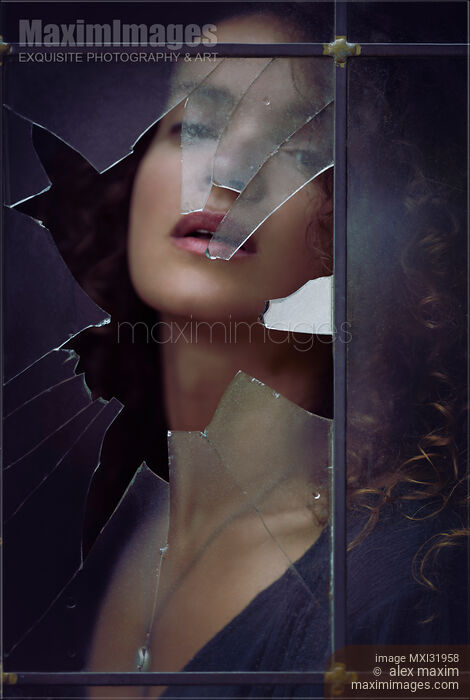 Beautiful woman sensual face behind a broken window shattered glass in a dark house Stock photo of Beautiful woman sensual face behind a broken window shattered glass in a dark house Buy commercial use license at MaximImages