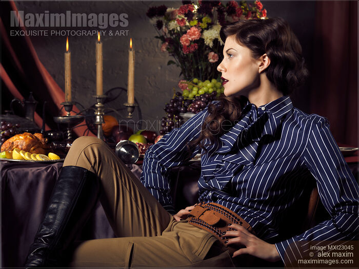 Beautiful Woman Sitting at a Festive Table Stock photo of Beautiful Woman Sitting at a Festive Table Buy commercial use license at MaximImages