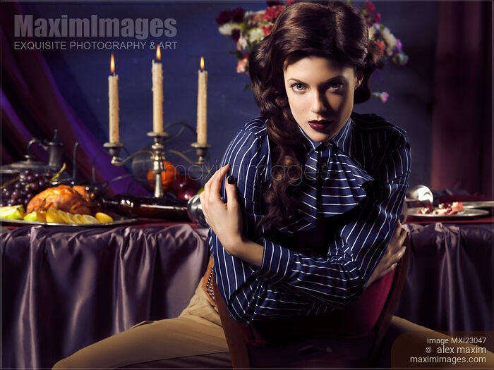 Beautiful Woman Sitting at a Festive Table Stock photo of Beautiful Woman Sitting at a Festive Table Buy commercial use license at MaximImages