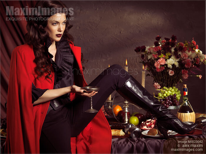 Beautiful Woman Sitting on a Festive Table Stock photo of Beautiful Woman Sitting on a Festive Table Buy commercial use license at MaximImages