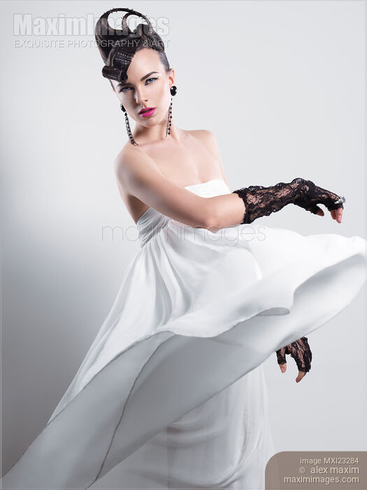 Beautiful Woman with a Creative Hairstyle Wearing a Long White Dress Stock photo of Beautiful Woman with a Creative Hairstyle Wearing a Long White Dress Buy commercial use license at MaximImages