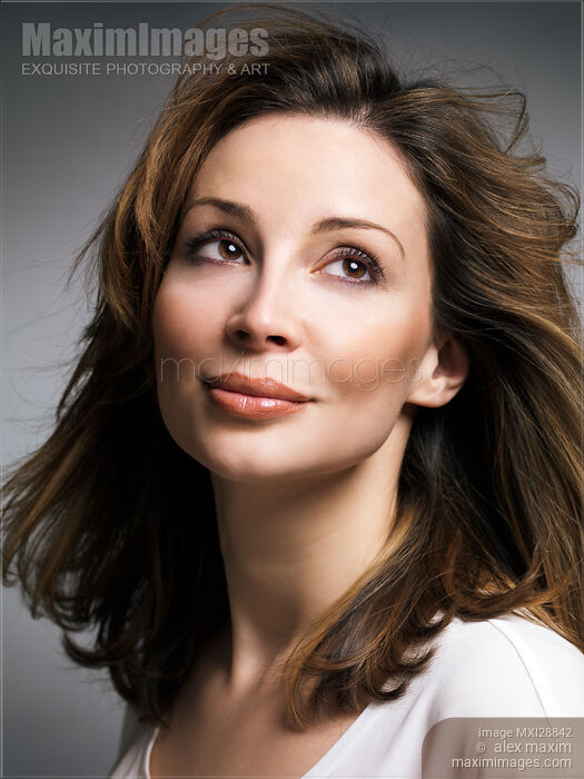 Beautiful woman with brown hair and daydreaming expression Stock photo of Beautiful woman with brown hair and daydreaming expression Buy commercial use license at MaximImages