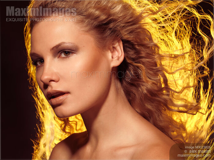 Beautiful Woman with Flying Golden Hair Stock photo of Beautiful Woman with Flying Golden Hair Buy commercial use license at MaximImages